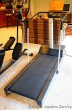 Precor 9.2S smaller sized treadmill, works well. It looks as though a piece of plastic has been