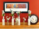 Seven decorative bottles with faux flowers; 12