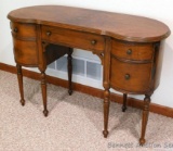 Antique vanity table or writing desk has two drawers on the right side and a cabinet door on the