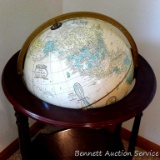 Cram's Imperial World globe with magazine or book holder incorporated into stand. 38