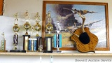 Collection of softball and archery trophies, tallest is 17