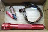 Three cell MagLite, works. Victorinox pocket knife in fair to good shape. Duck call, leather rifle