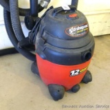 Shop-Vac 5 hp 12 gallon wet/dry vacuum with lots of hose. Runs and works, squeaks a little when it's