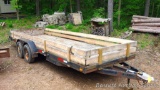 Tandem axle trailer has a 20' x 6-1/2' bed and has stabilizer jacks at rear corners. Six lug rims.