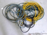 5 Construction extension cords in various lengths, some have tape on the ends.