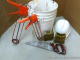 5 Gallon pail filled with big and small caulk guns, extension ladder protectors and hard hat.