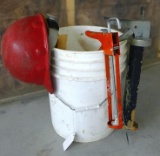 5 Gallon pail filled with wooden door shims, hard hat and 13