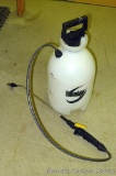 Roundup 2 gallon plastic sprayer with hose and nozzle.