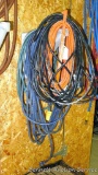 4 Lengths of electrical cords of various lengths, one incl a trouble light.