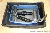 Three metal grease guns; two plastic tubs, largest is 20' x 26