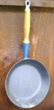LeCreuset #24 cast iron frying pan with blue enamel coating.