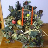 Assortment of faux greenery, some in a wicker basket, brass toned candle sticks, more.