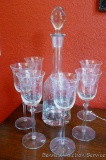 Pretty decanter with glass stopper and six wine glasses have a matching cut grape and leaf design.