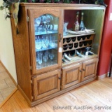 Lighted wine cabinet has been revamped from a nice solid wood entertainment center. Has glass