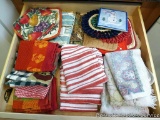 Assorted dish towels, trivets, hot pads.