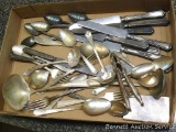 Variety of silver plated flatware including servers, forks, knives, spoons. Largest piece is a ladle