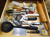 Kitchen utensils including KitchenAid ice cream scoop; tongs, turners, pizza cutter, maple rolling