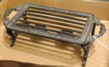Cast iron trivet or warming plate has a place for two little candles. Measures 12