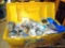 Plano box filled with electrical supplies. Includes lamp holders, wire strippers, outlet boxes and