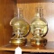 Two wall mountable brass toned oil lamps are each approx. 10-1/2