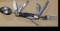 Really cool camp knife includes fork, spoon, corkscrew, knife, scissors, more. Roughly 4-3/4