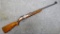 IMC2 bolt action .22 rifle. Rifle has a fixed rear blade sight and two flip up leaves. Barrel is