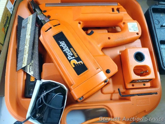 Paslode Impulse cordless framing nailer with 2 batteries, charger, framing fuel, manuals, and case.