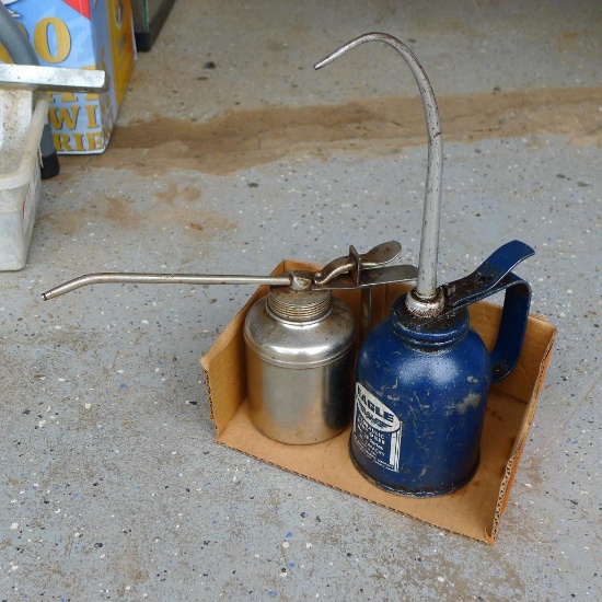 Two metal oil cans, largest is Eagle brand 12-1/2" tall.