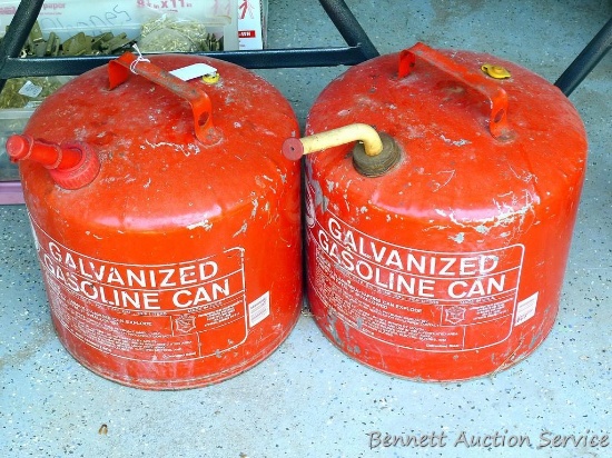 Two five gallon gas cans. Vent hole on one has been plugged with a screw.