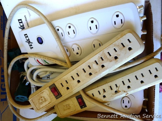 Two surge protectors, two power strips and two three way plug-in adaptors.
