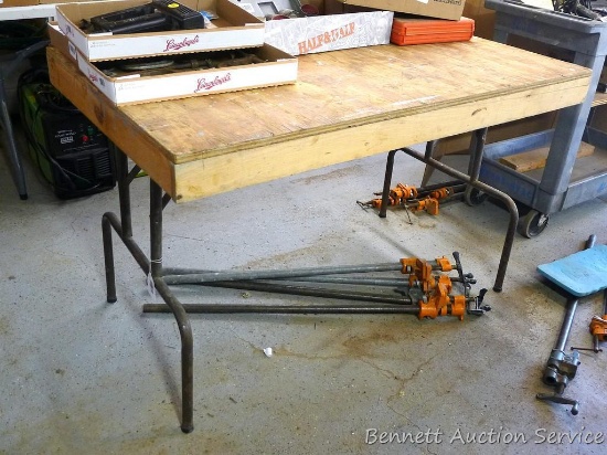 Wooden work table with metal legs is 30" x 48" x 30" tall.
