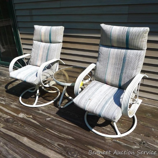 Rocking swiveling deck or porch chairs, plus a glass topped side table.