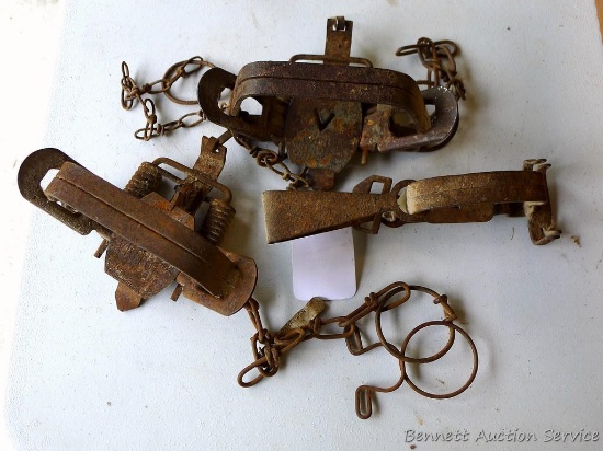 Two Victor No 2 coil spring traps, plus another Victor trap. Larger ones are about 6-1/2" x 5-1/2" x