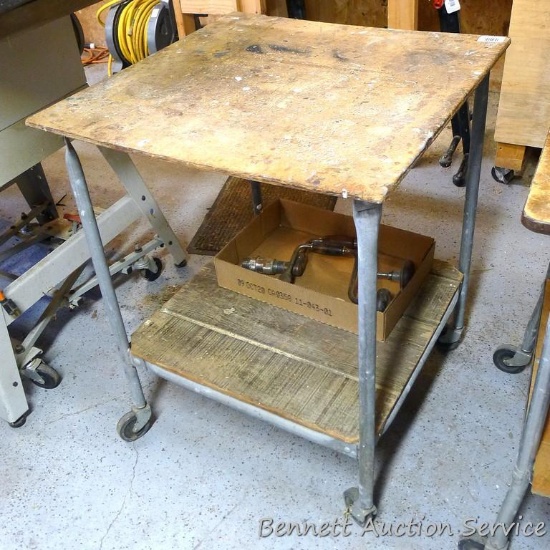 Handy rolling cart has an extra shelf below. Measures approx 24" x 24" x 30-1/2" tall. Rolls