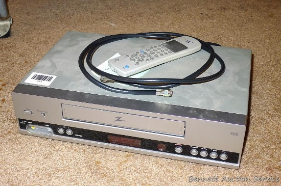 Zenith VHS video player with remote, seller states that it works. Cabinet measures 14" wide.