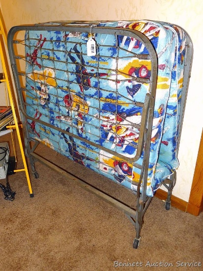 Folding cot with Micronauts cover is very vintage. 39" wide x 42" high x 15" as folded.