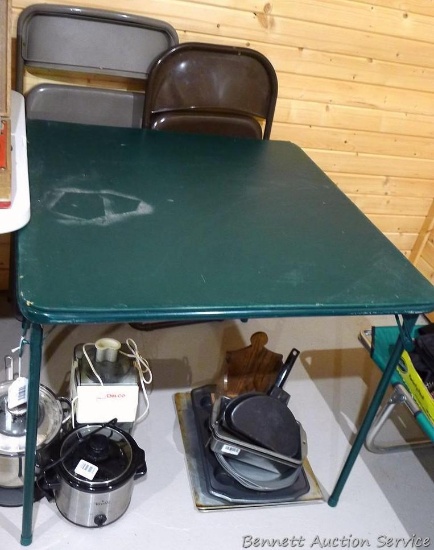 Standard card table with a couple of mismatched folding chairs.