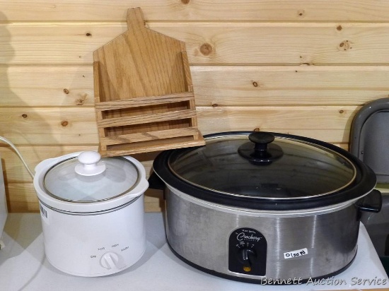 West Bend The Crockery Cooker and a smaller crock pot/slow cooker, plus a handmade napkin holder.