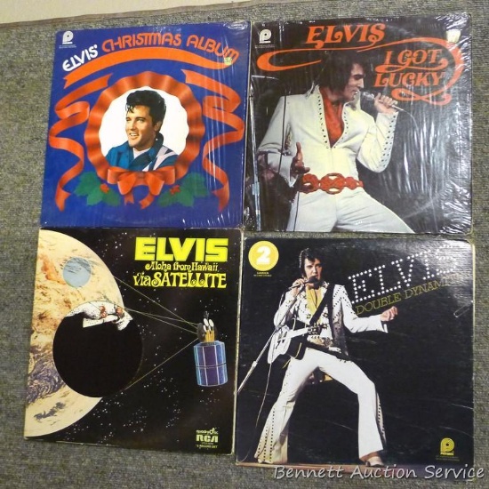 Several Elvis Presley record albums include Double Dynamite, Aloha From Hawaii via Satellite, I Got