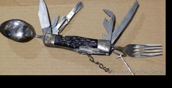 Really cool camp knife includes fork, spoon, corkscrew, knife, scissors, more. Roughly 4-3/4" x 2" x