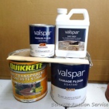 Gallon of Quikrete concrete stain appears to be full; gallon of Valspar garage floor coating base