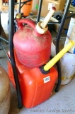 Five gallon gas tote; 1-1/4 gallon gas tote, vent cap has been damaged.