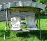 Two-person swing with canopy and glass-topped arm rest. Well built swing is over 6' wide. Clean or