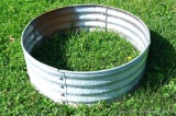 Galvanized steel fire ring is 3' x 1'.