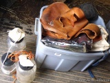 Rubbermaid tote filled with horse tack including Weaver 1' and other halters, lead ropes, saddle