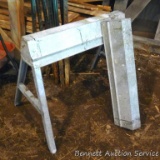 Metal sawhorses have folding legs and measure about 31