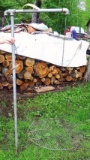 Galvanized water pipe 5' tall that hold up a campfire grate.