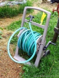 Rustproof portable hose reel with hose.