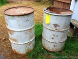 Two steel 55 gallon barrels with lids.