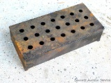 Cast iron smoker box for wood chips in gas grill.